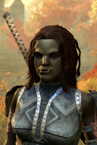 Screenshot of Veghra from the login screen of ESO. She is an Orc with olive-green skin and tousled dark brown hair, wearing steel-blue light armor with white and red trim, and a battleaxe on her back.